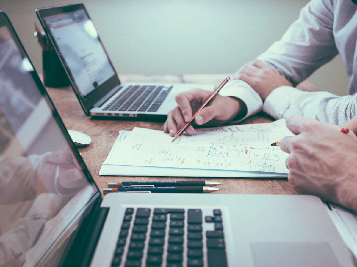 People reviewing documents together around a table.